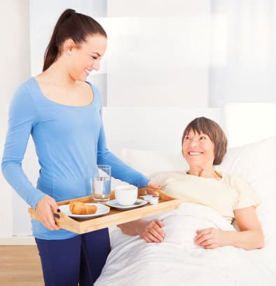 image of woman preparing meal for senior woman image of woman preparing meal for senior woman