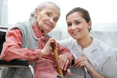 image of senior woman and caregiver smiling