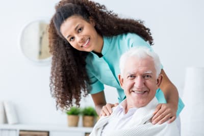 image of senior man and caregiver smiling