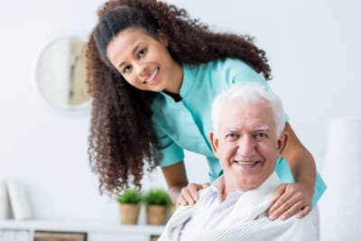 image of senior man and caregiver smiling image of senior man and caregiver smiling